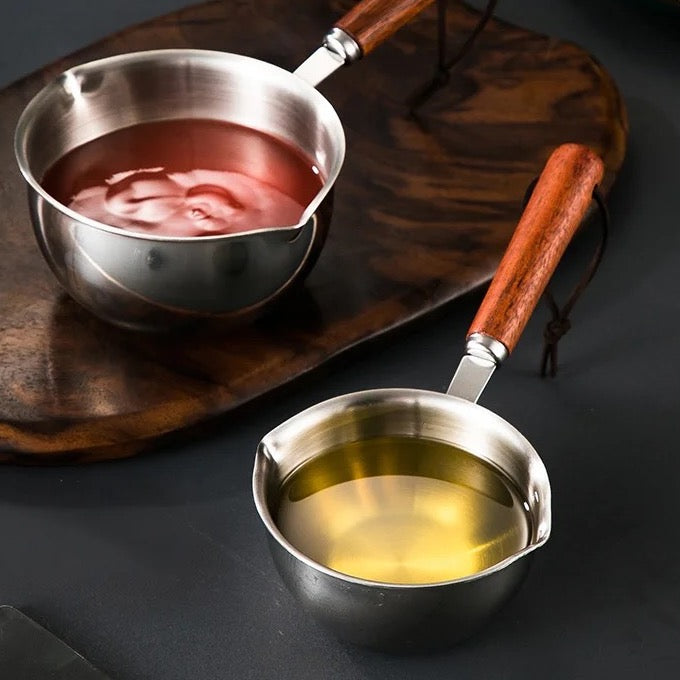 Two stainless steel pots with wooden handles